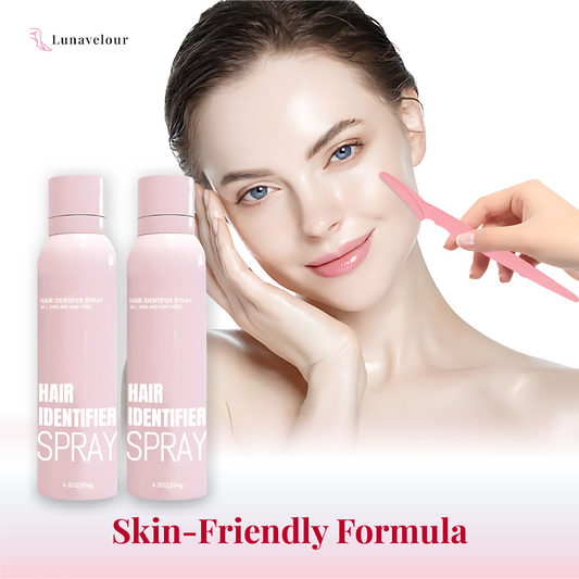 Woman applying a product to her face with pink bottles labeled 'Hair Identifier Spray' on a white background.